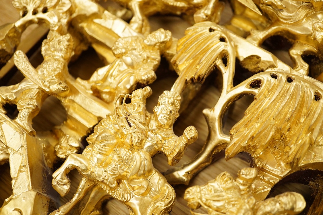 A Chinese carved gilt wood panel, depicting battle scenes, 50cm high
